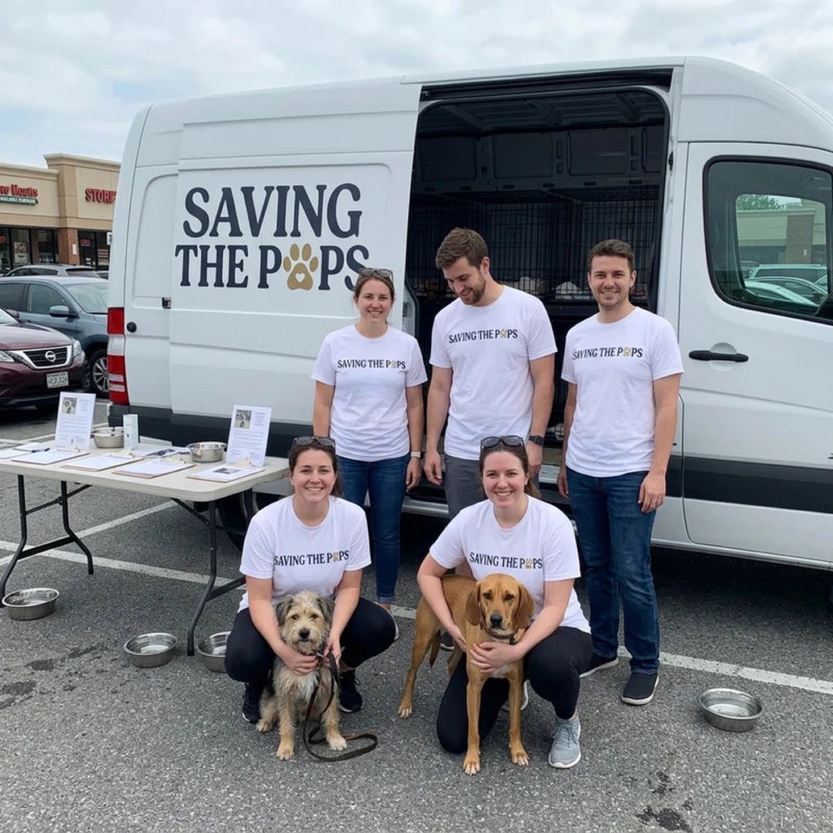 The Saving The Pups team with the rescue van